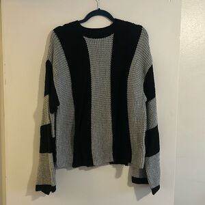 Black and gray striped sweater. Not see-through, size large. New without tags.